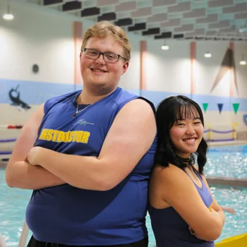 Two workers standing back to back